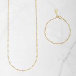 Matching gold beaded jewelry including a waist chain and a bracelet