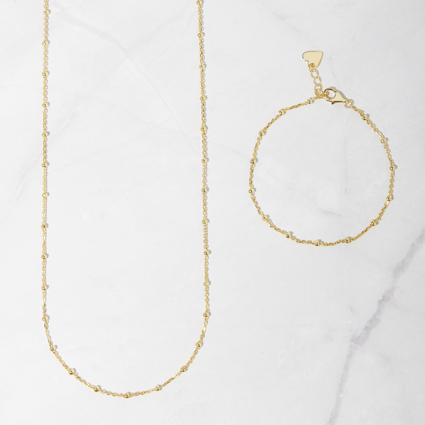 Matching gold beaded jewelry including a waist chain and a bracelet