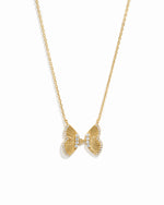 Statement gold butterfly pendant with cz stones on white background