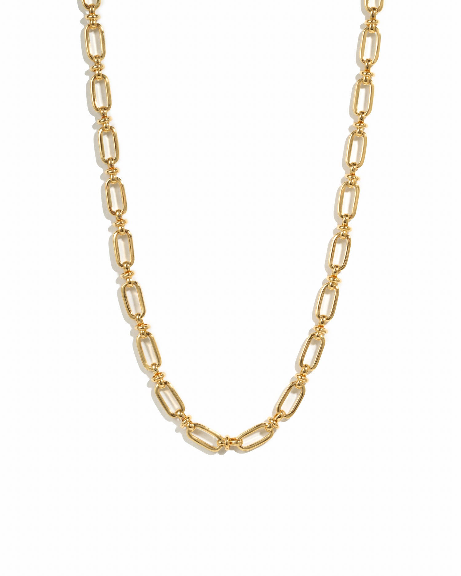 Gold statement chain link necklace on white background