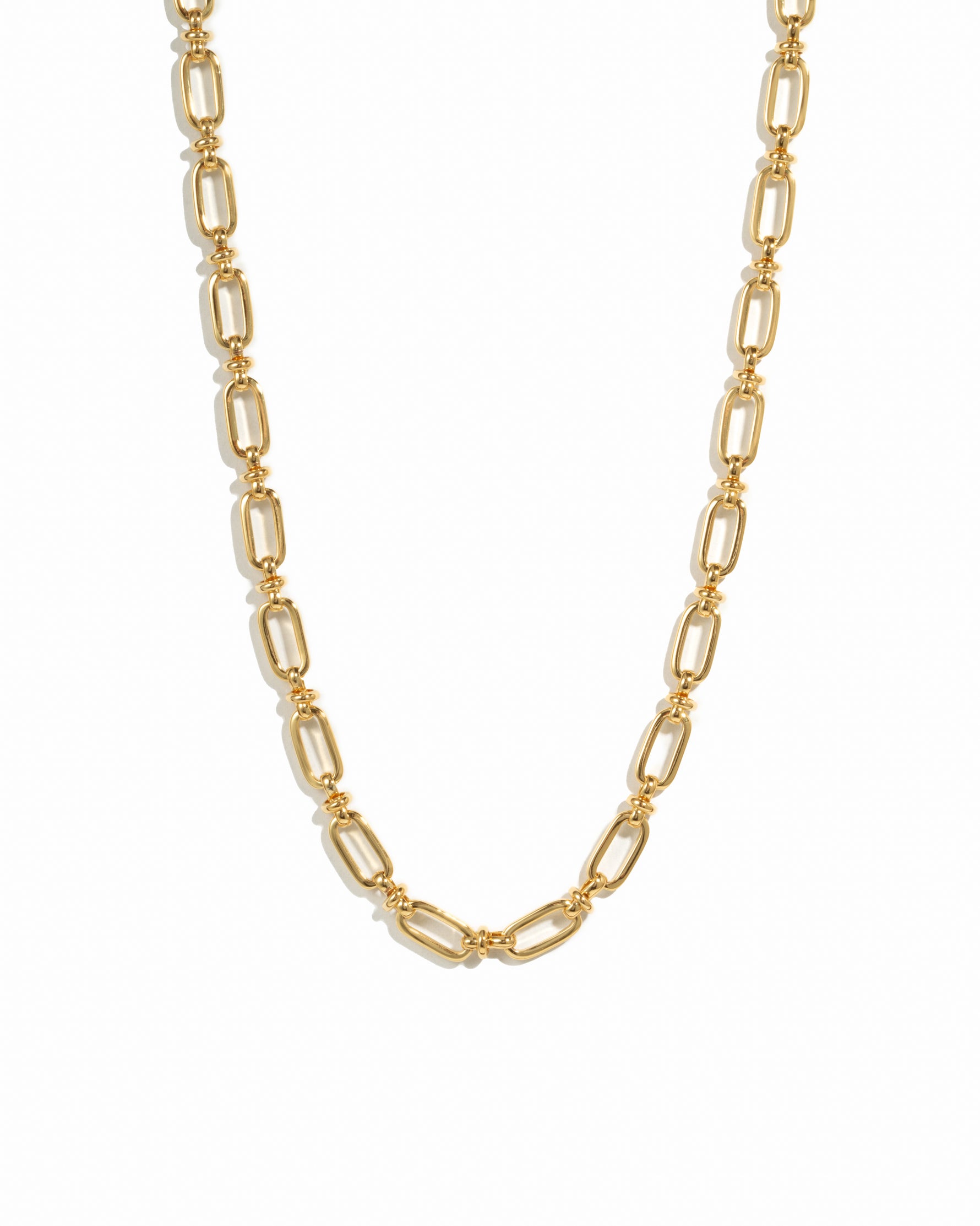 Gold statement chain link necklace on white background