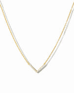 delicate gold chevron necklace on white background.