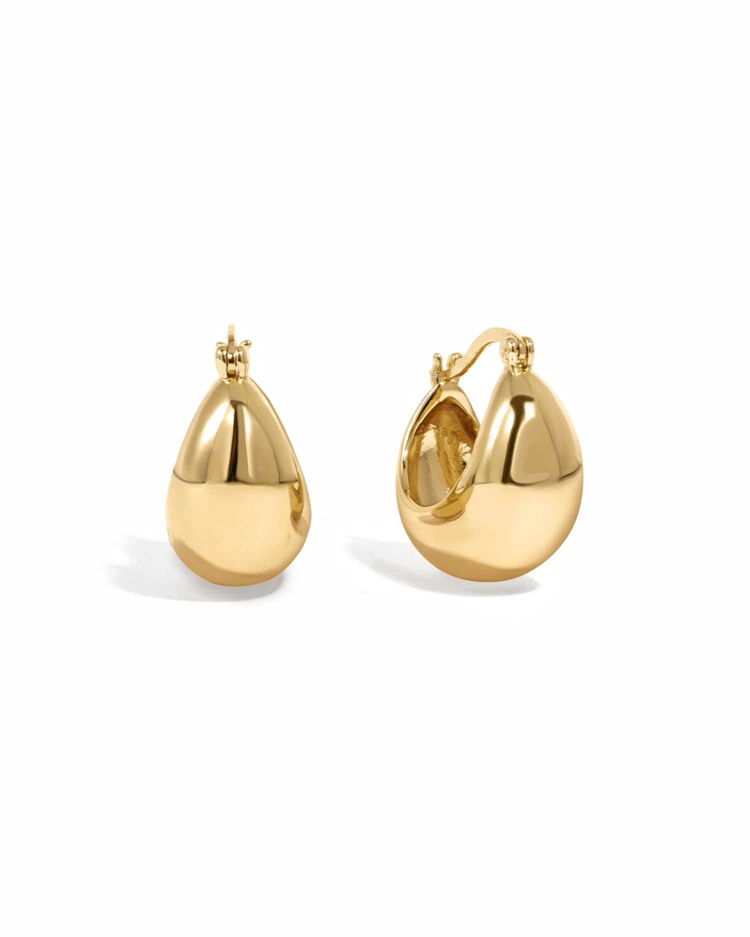 Thick chunky gold basket hoop earrings on white background.