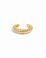 Gold adjustable croissant ear cuff on white background