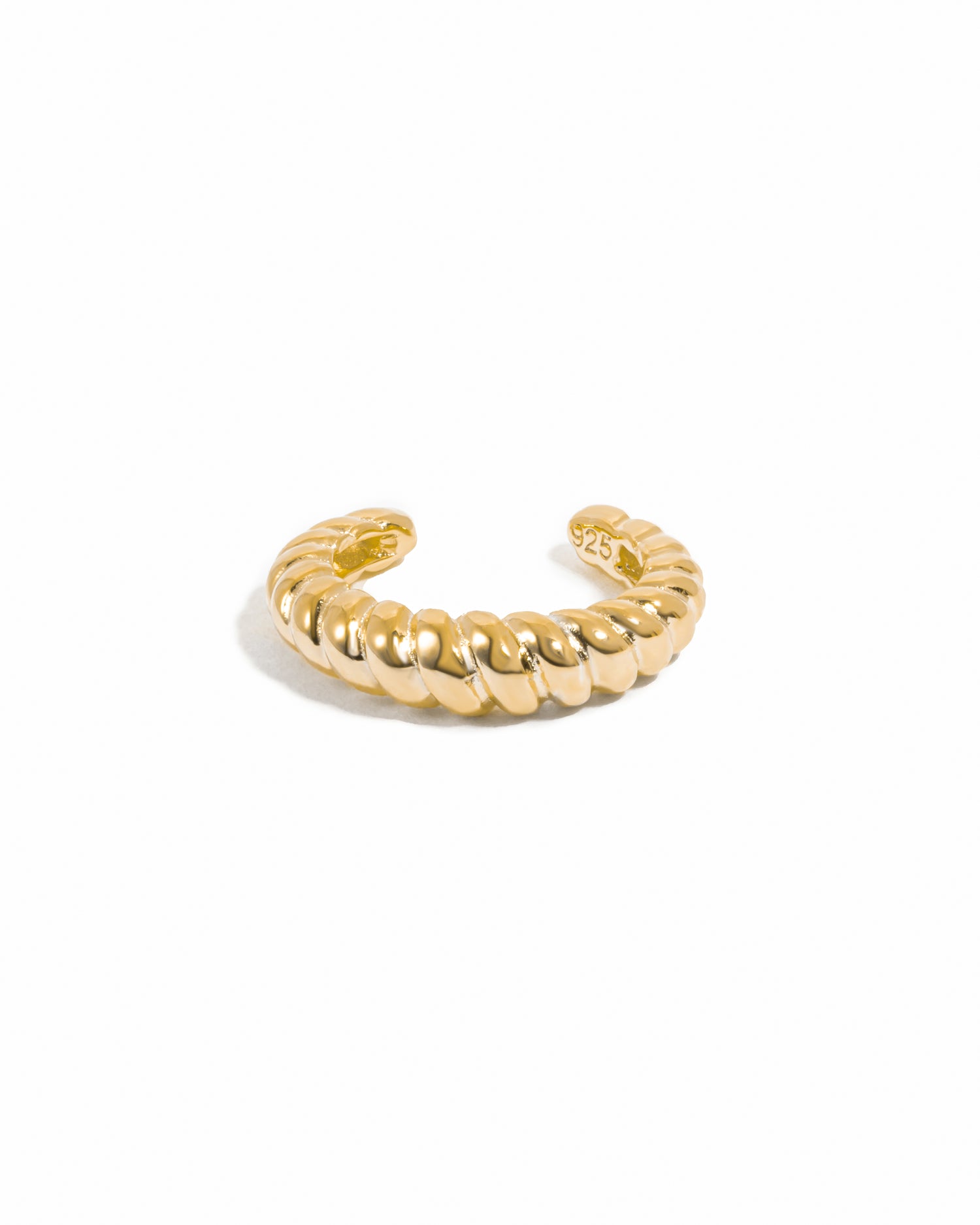 Gold adjustable croissant ear cuff on white background
