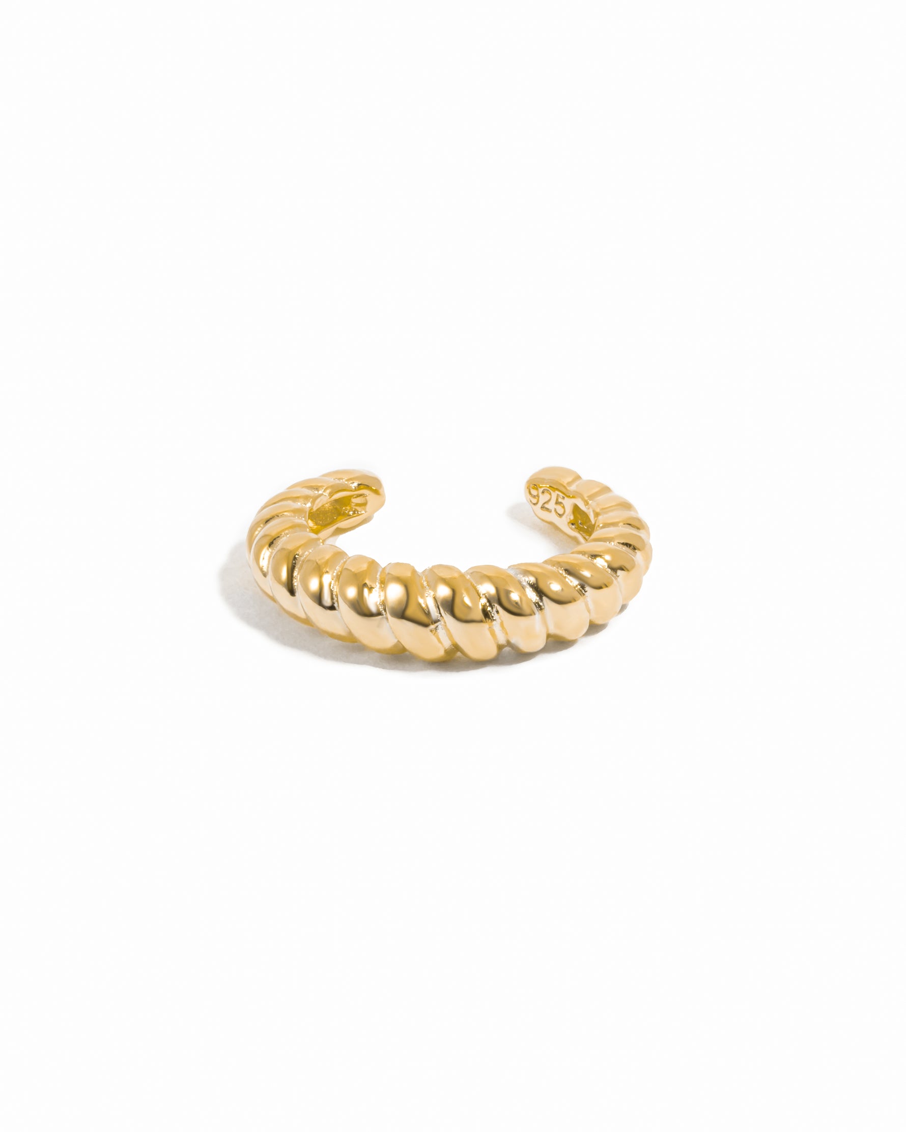 Gold adjustable croissant ear cuff on white background