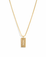 Gold dainty dog tag customizable necklace on a box chain with a name on it.