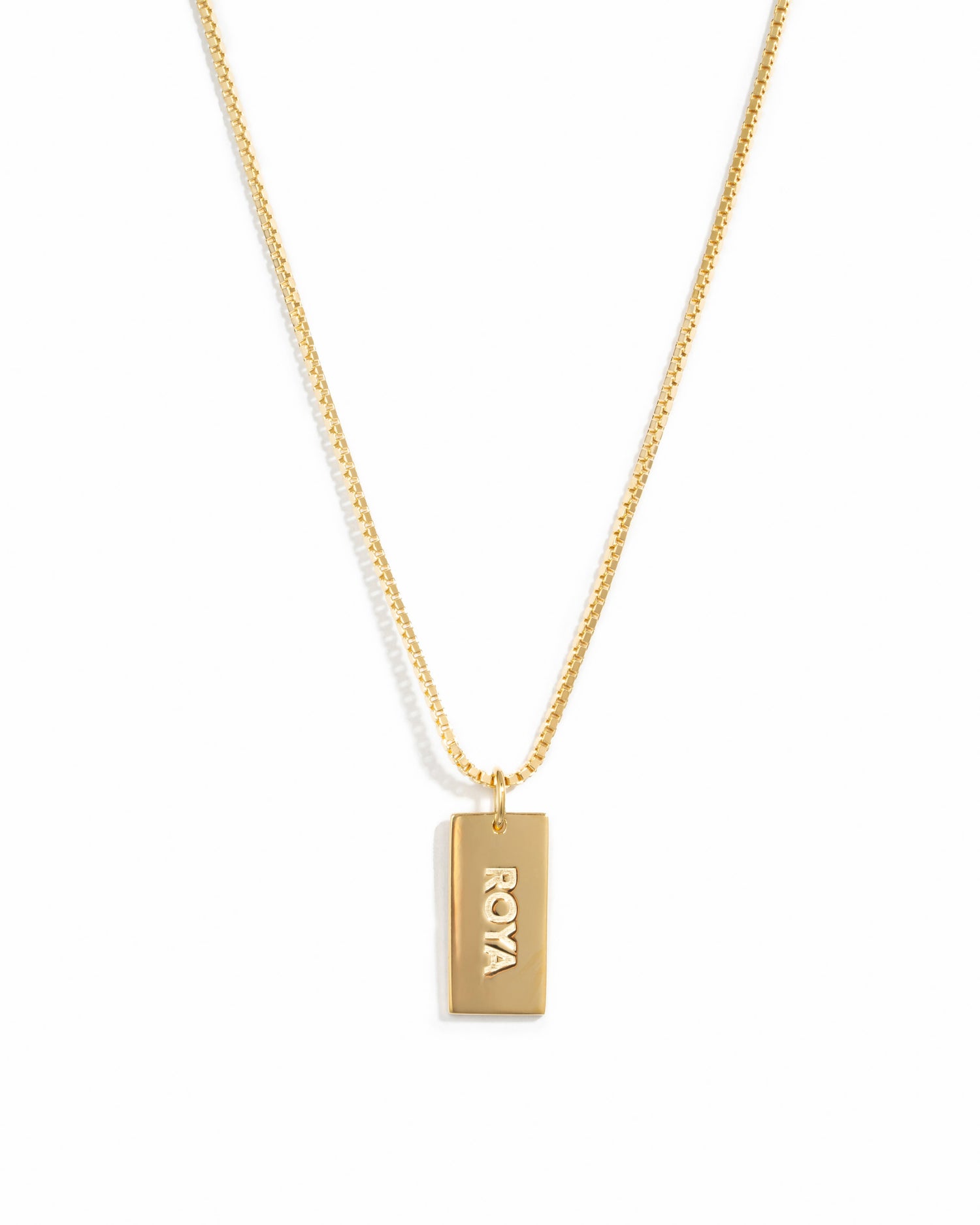 Gold dainty dog tag customizable necklace on a box chain with a name on it.