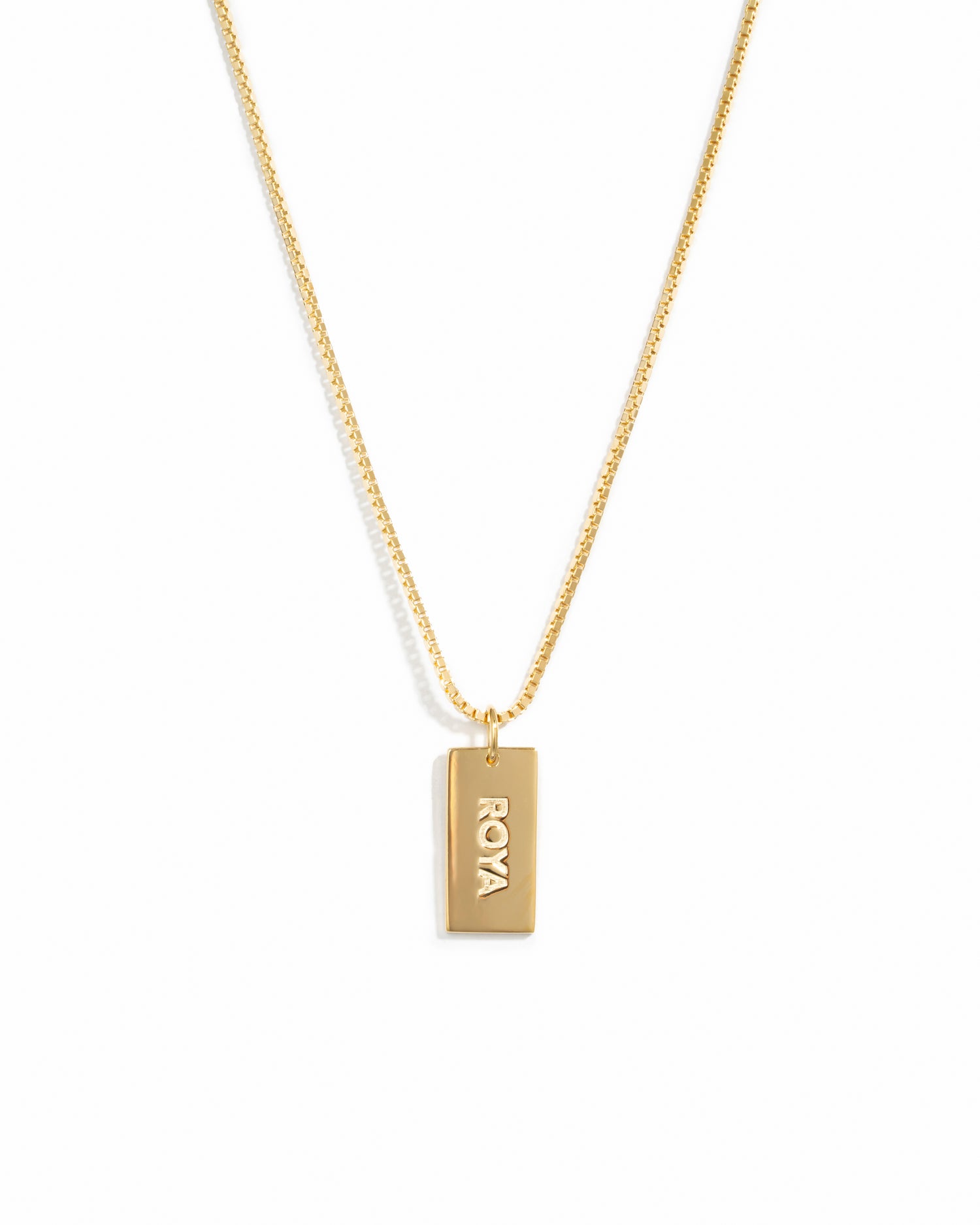 Gold dainty dog tag customizable necklace on a box chain with a name on it.