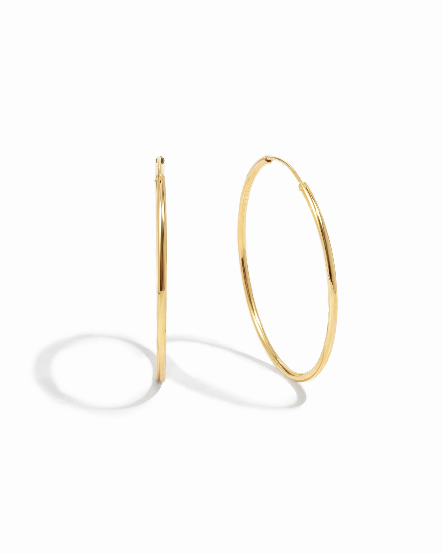 closeup image of dainty thin hoop earrings