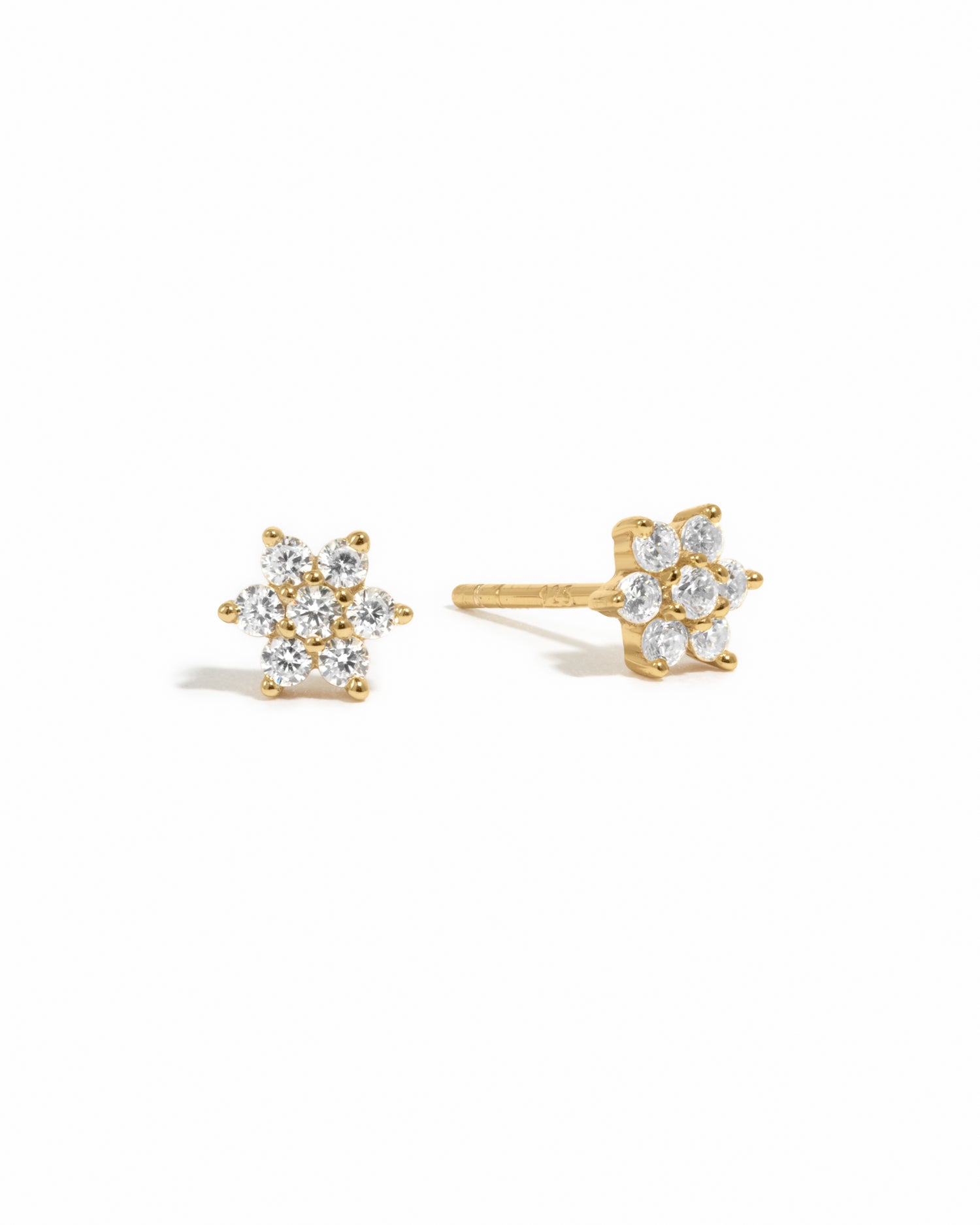 Gold dainty diamond cz flower stud earrings on white background.