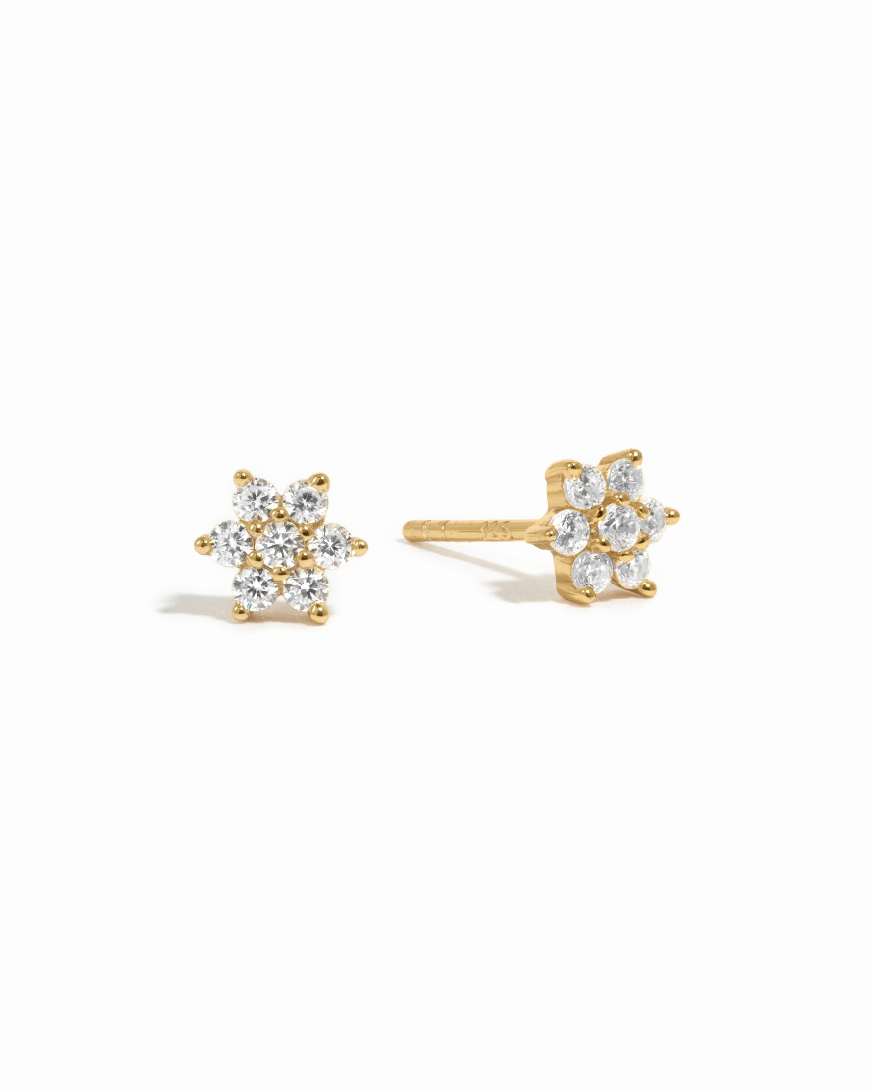 Gold dainty diamond cz flower stud earrings on white background.