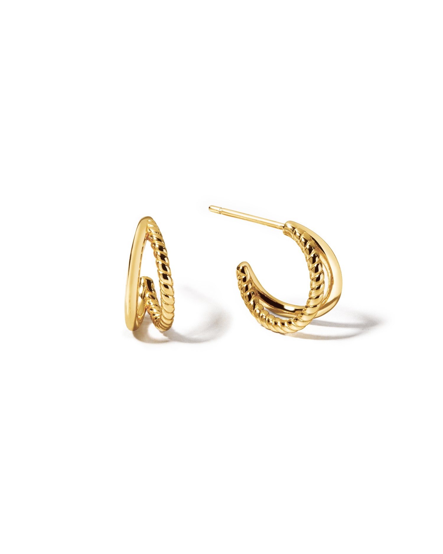 Delicate gold split shank hoop earrings with a spiral and plain side. 