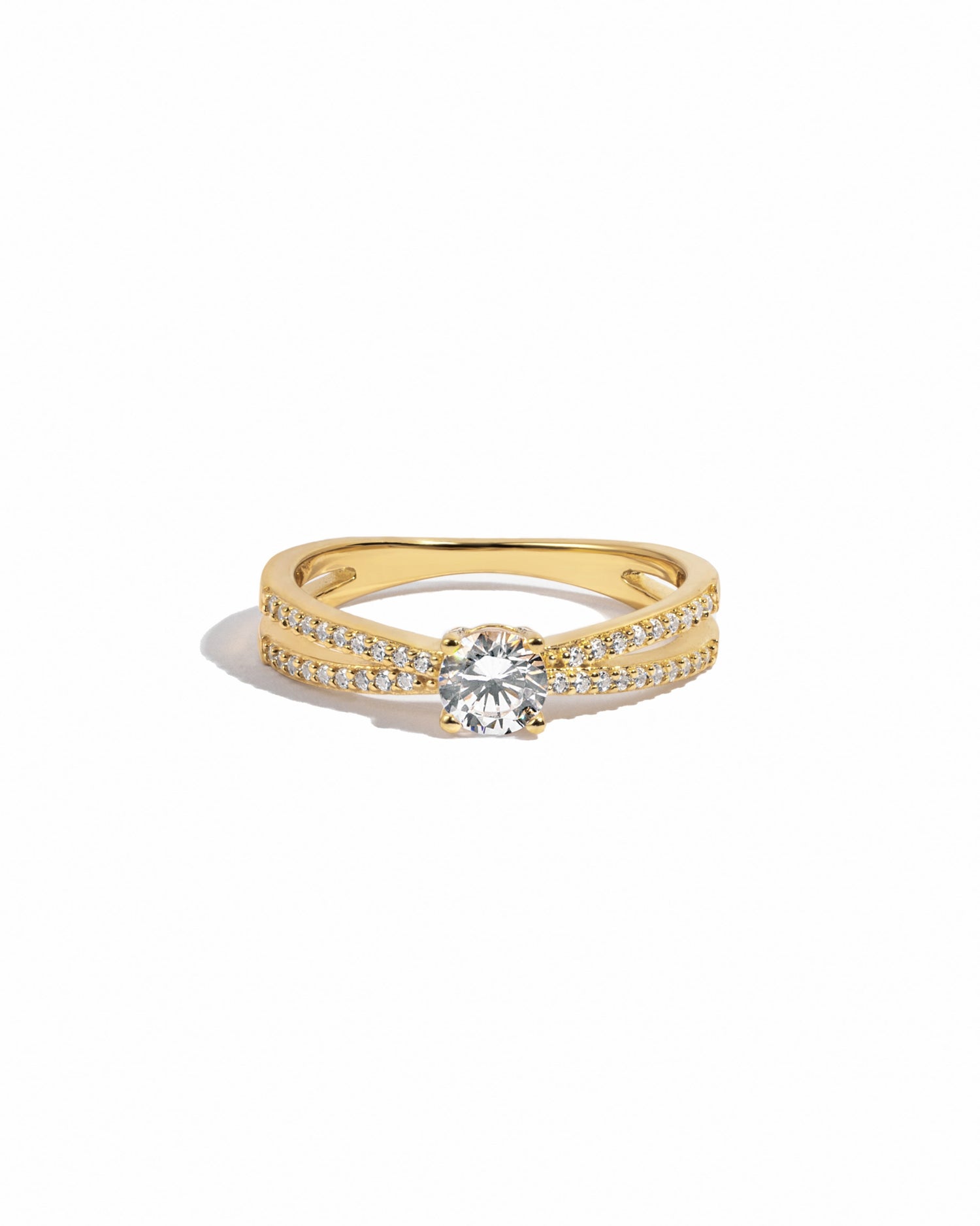 Gold double shank diamond cz solitaire ring in gold on white background. 