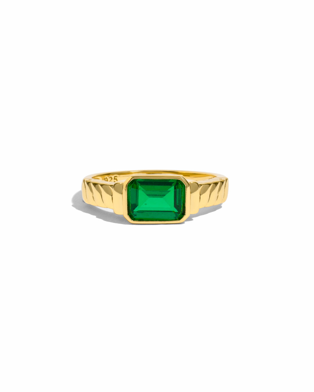 Gold Sami Jewels emerald statement ring featuring a large green gemstone and intricate design.