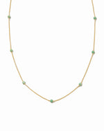 Emerald pavé beaded necklace on white background. 