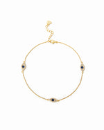 Delicate gold evil eye charm ankle bracelet with sapphire center.