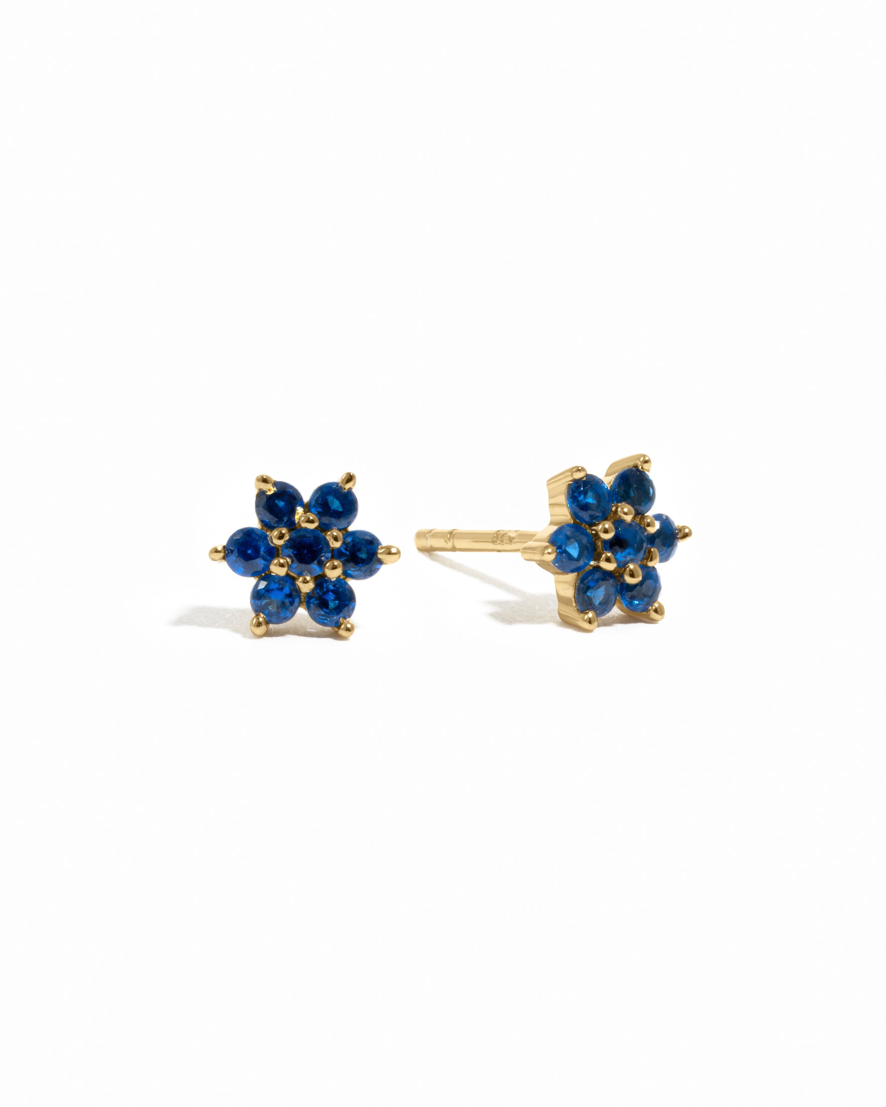Solid sapphire gemstone flower stud earrings in gold.