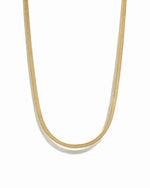 Gold herringbone chain necklace on white background.