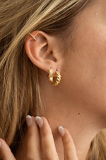 Model wearing gold glam everyday earring stack