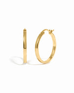 Gold hoop earrings on a white background