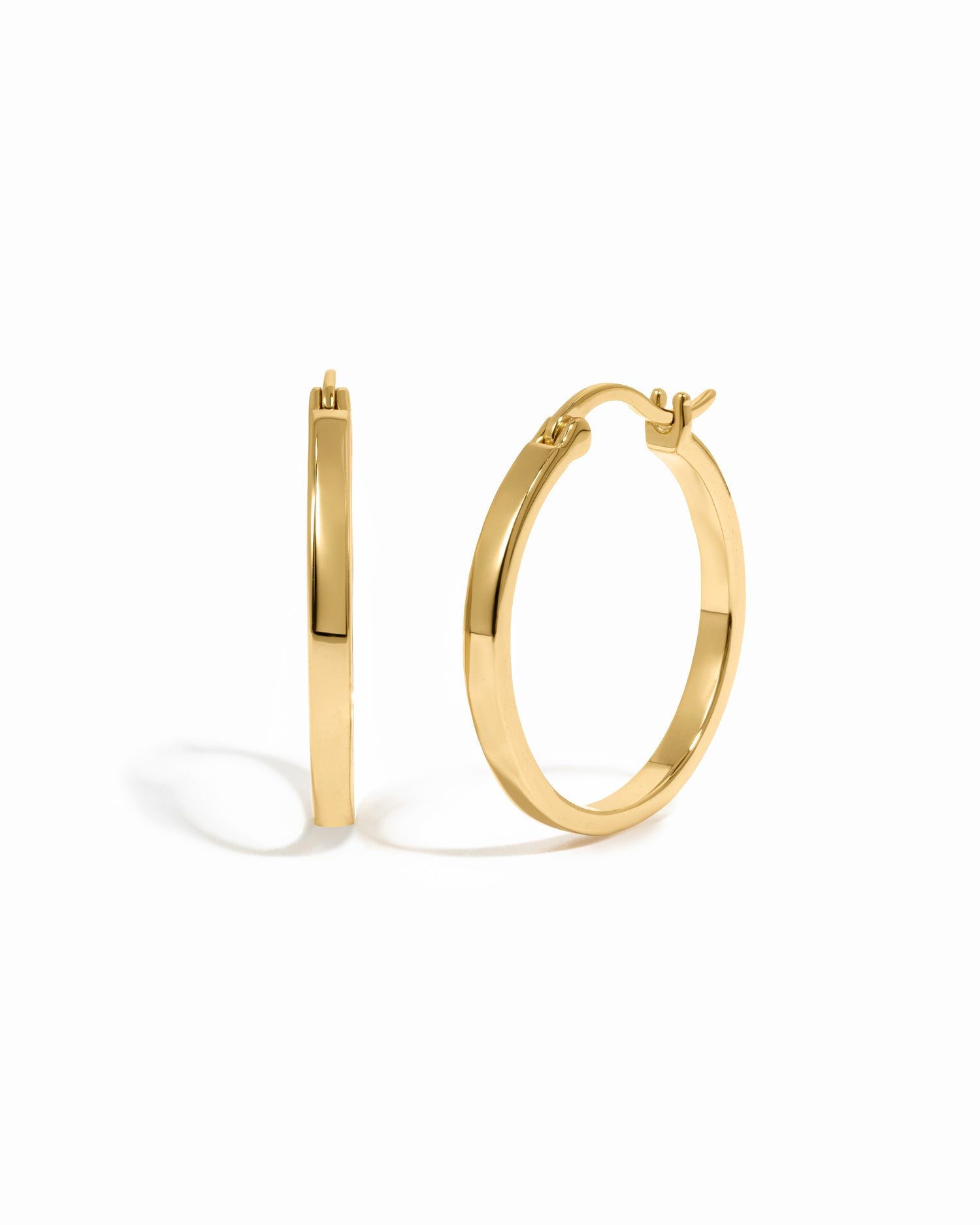 Gold hoop earrings on a white background