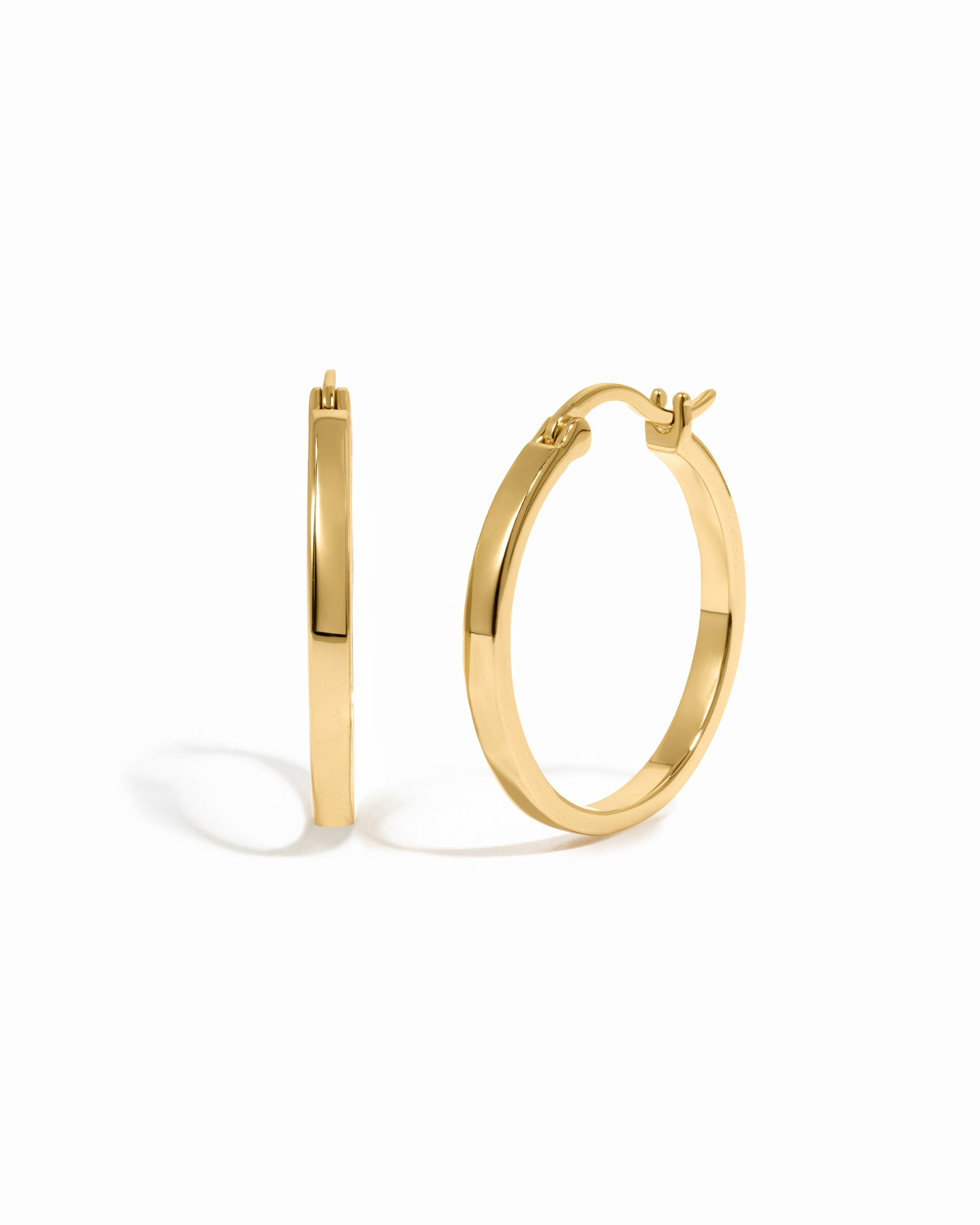 Gold hoop earrings on a white background
