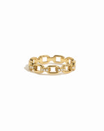 Dainty gold chain link ring with cz details on white background.