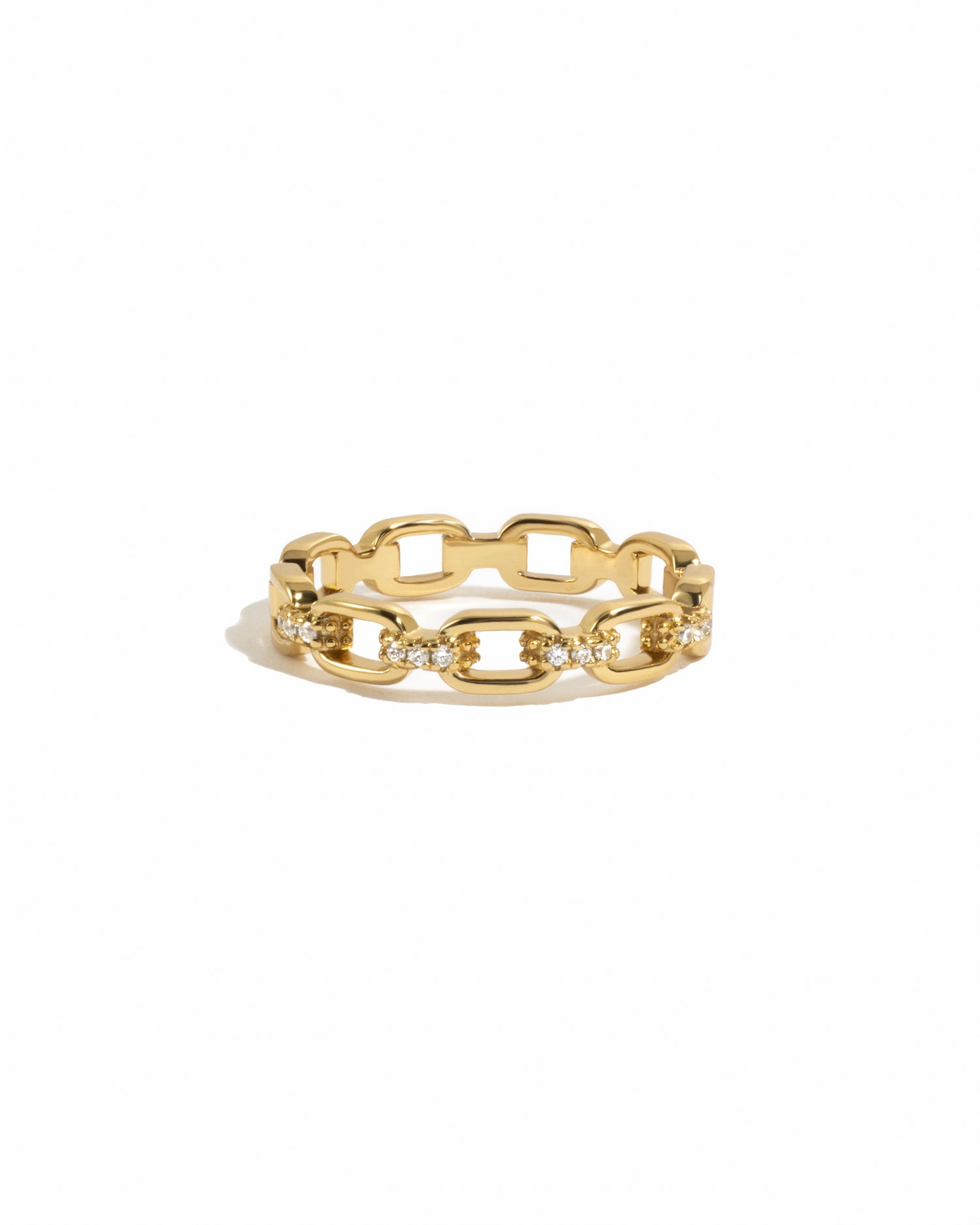 Dainty gold chain link ring with cz details on white background.