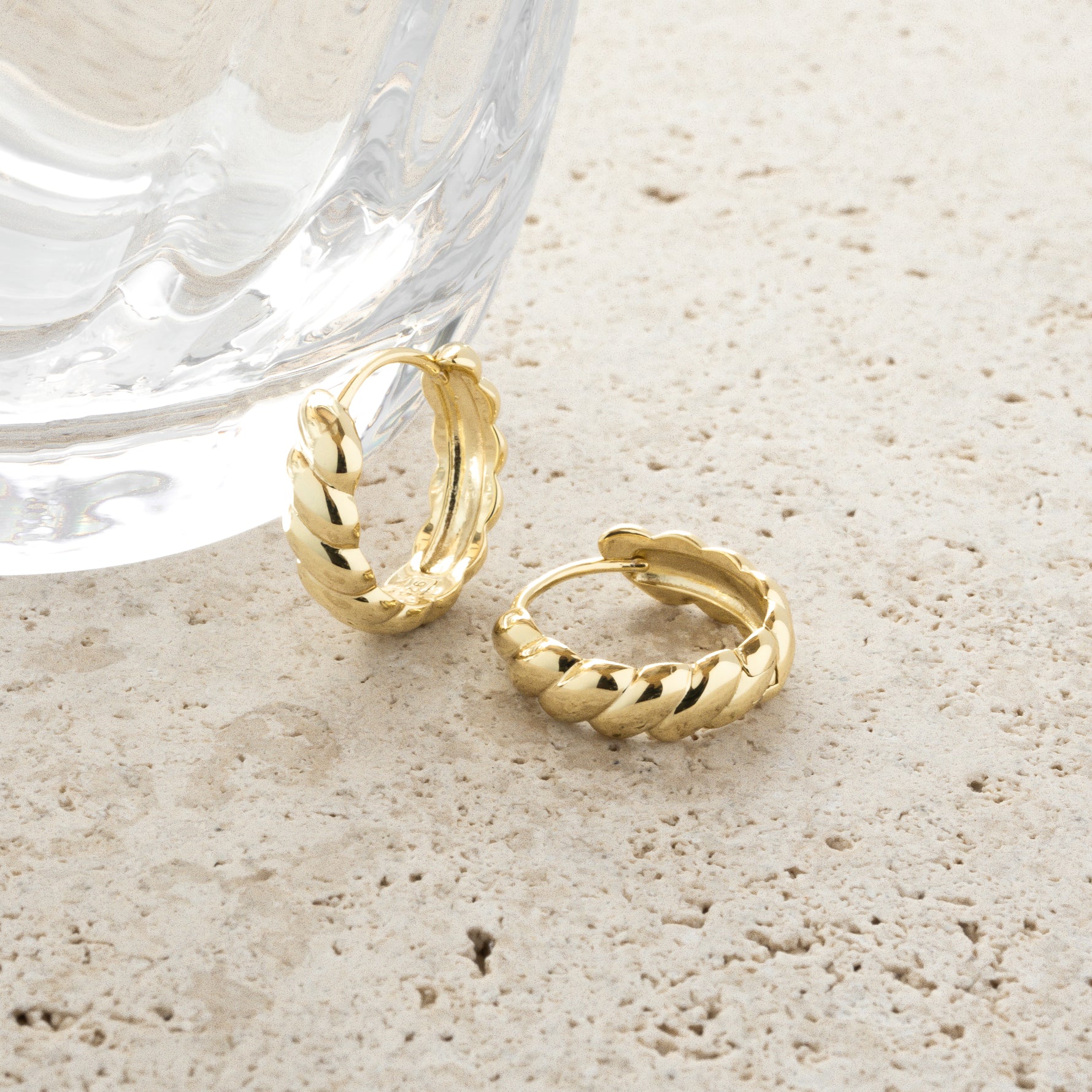 Unique round croissant hoop earrings in gold. 
