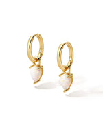 Gold removable opal tear drop charm earrings on white background.