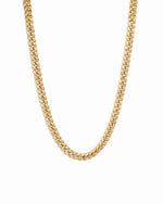 Gold curb chain link necklace on white background.