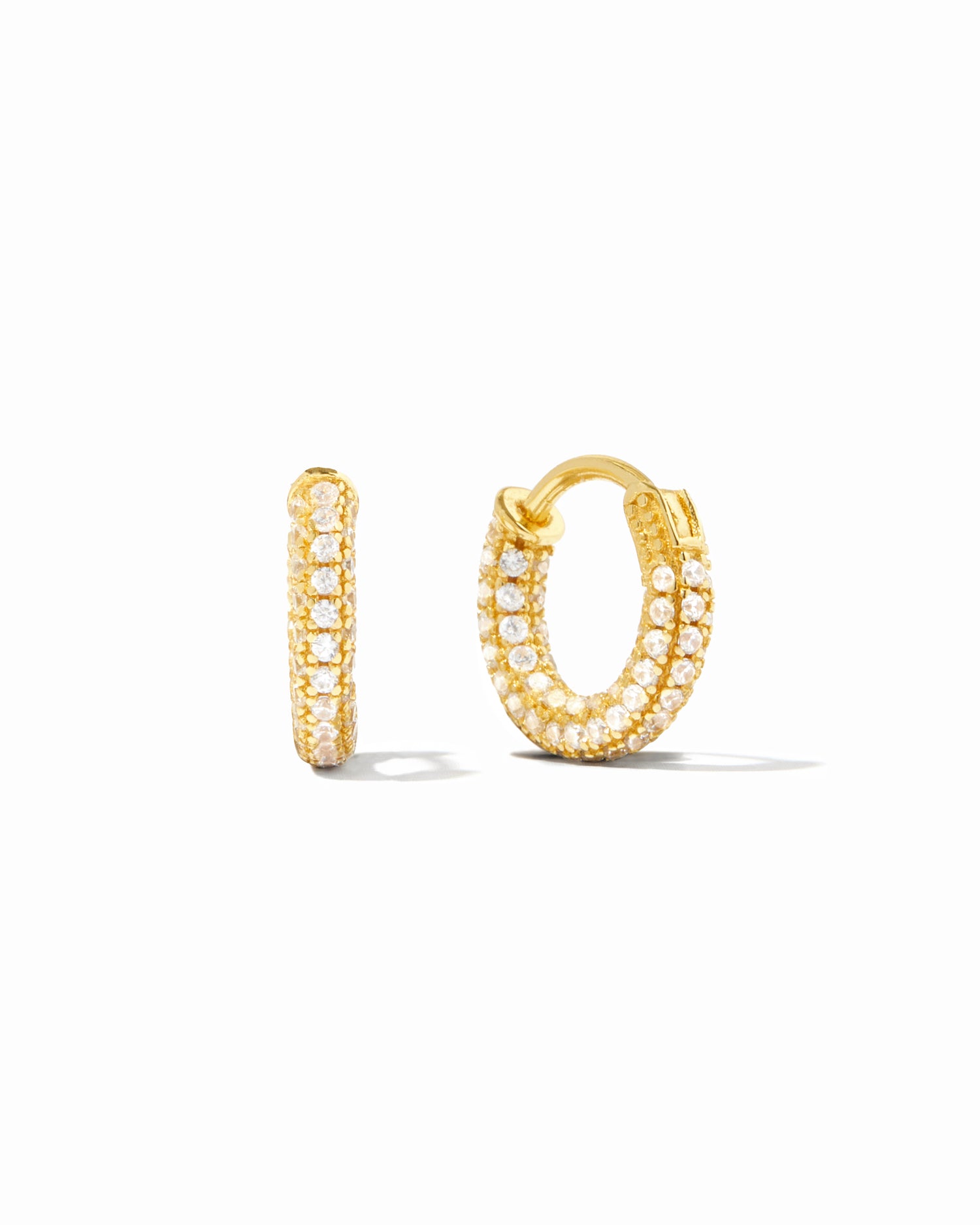 Small pavé gold hoop earrings on white background.