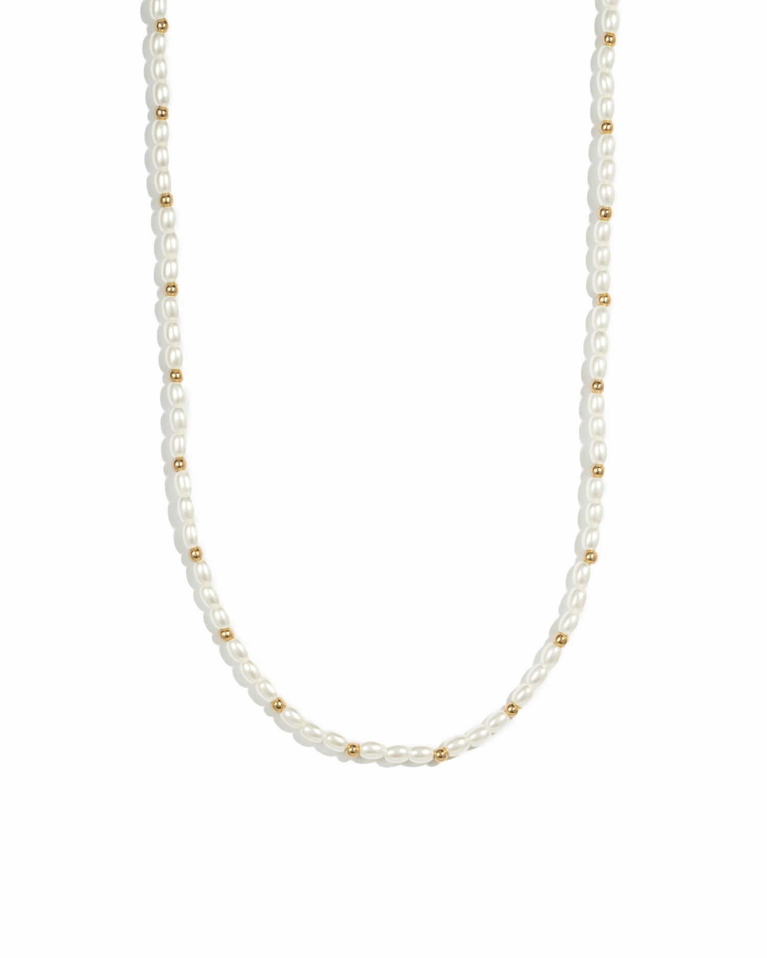 Gold beads and pearl beaded necklace on white background.