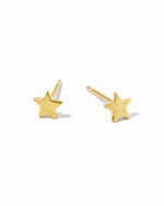 Dainty gold star studs on white background.