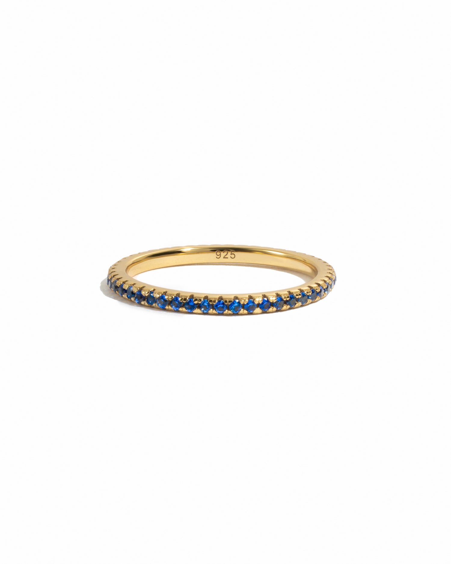 Minimalist birthstone sapphire eternity ring on white background. 