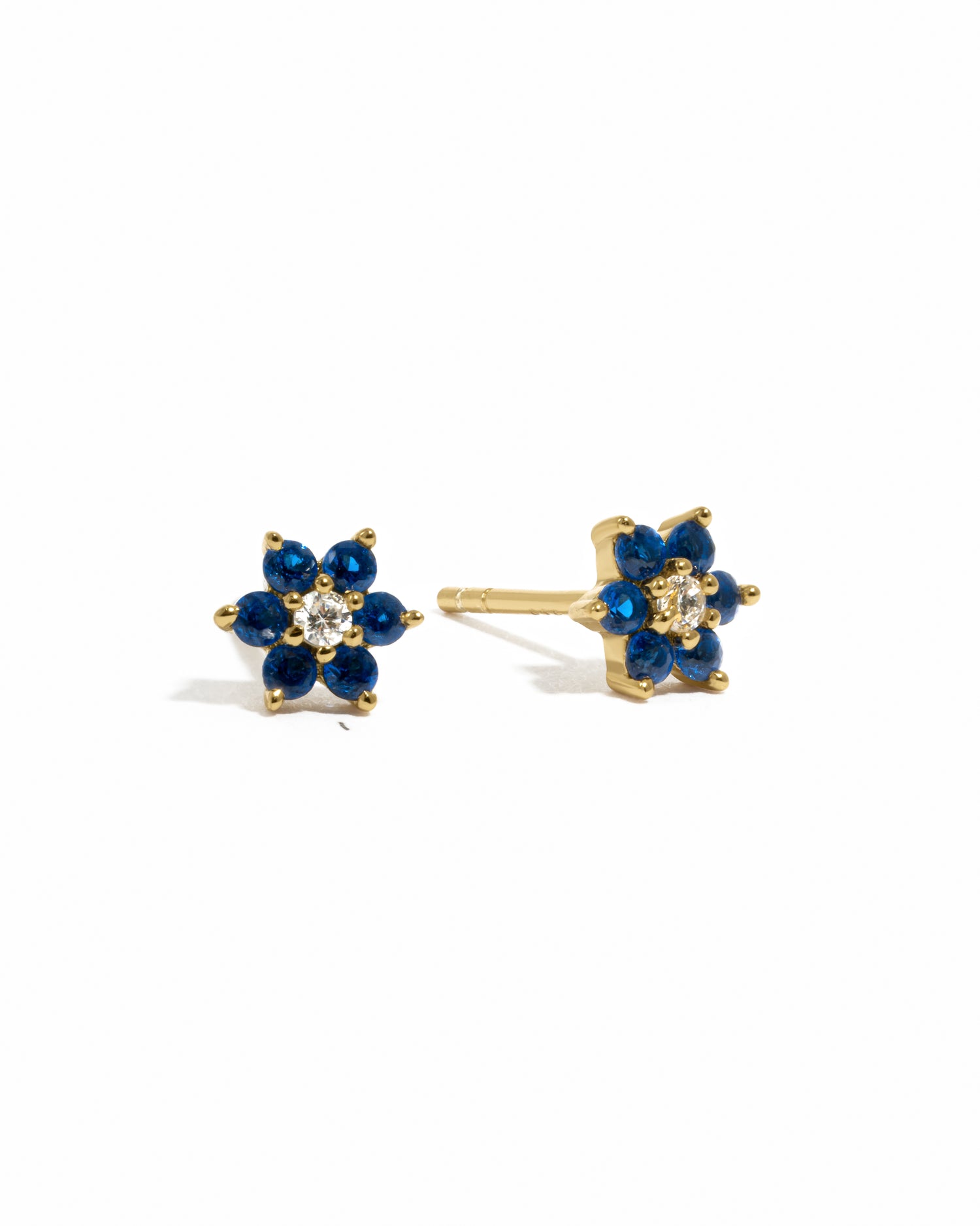 Gold sapphire flower stud earrings with white cz center stone.
