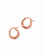 Rose gold hoop earrings on a white background