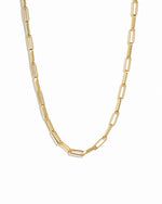Gold square statement paperclip necklace on white background.