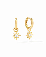 Dainty gold sunburst charm earrings with removable charm on white background.
