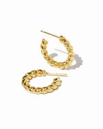 Gold spiral textured hoop earrings on white background