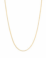 Delicate gold thin chain necklace on white background
