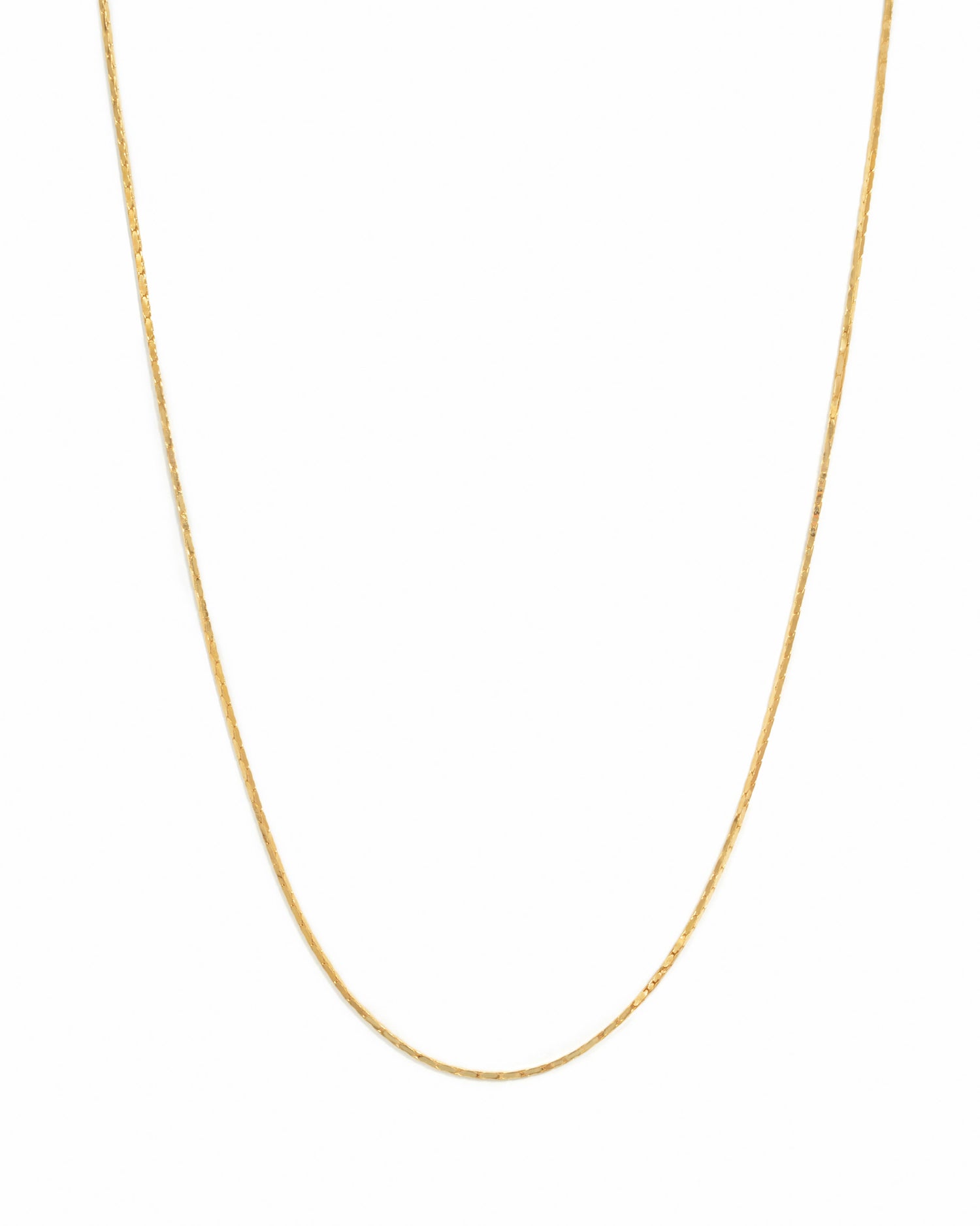 Delicate gold thin chain necklace on white background