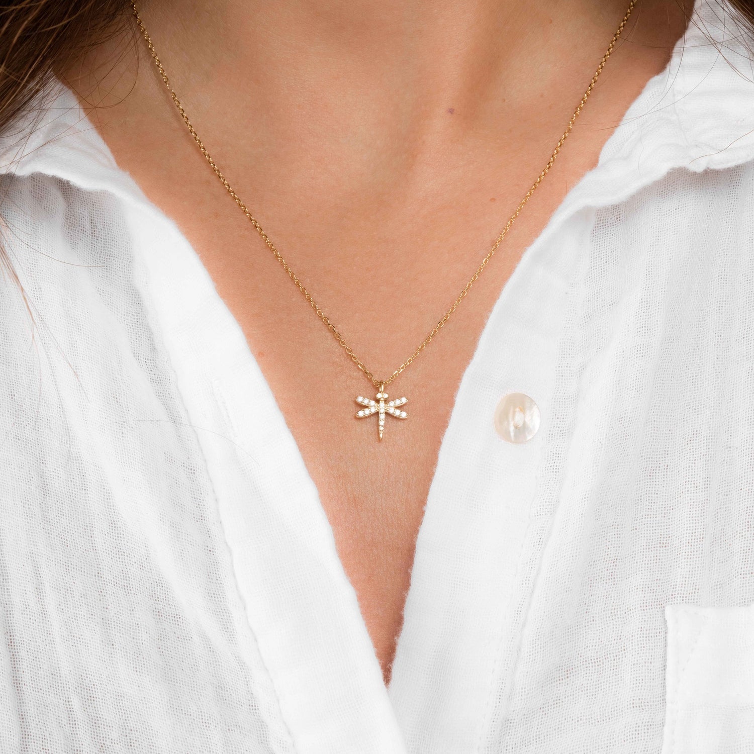 Gold dragonfly necklace from Sami Jewels featuring a minimalist charm, perfect for delicate jewelry collections.