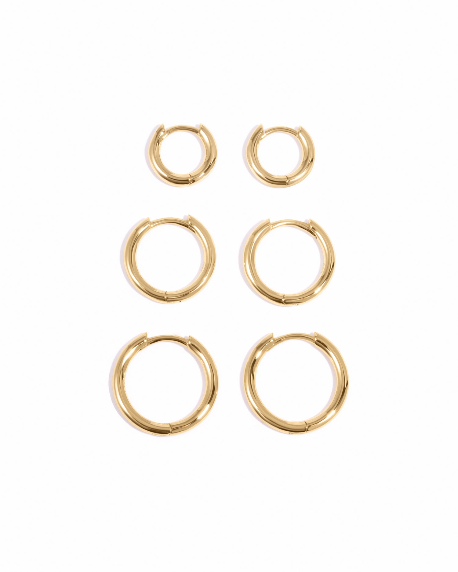 Gold small, medium, and big minimalist hoop earrings in a set