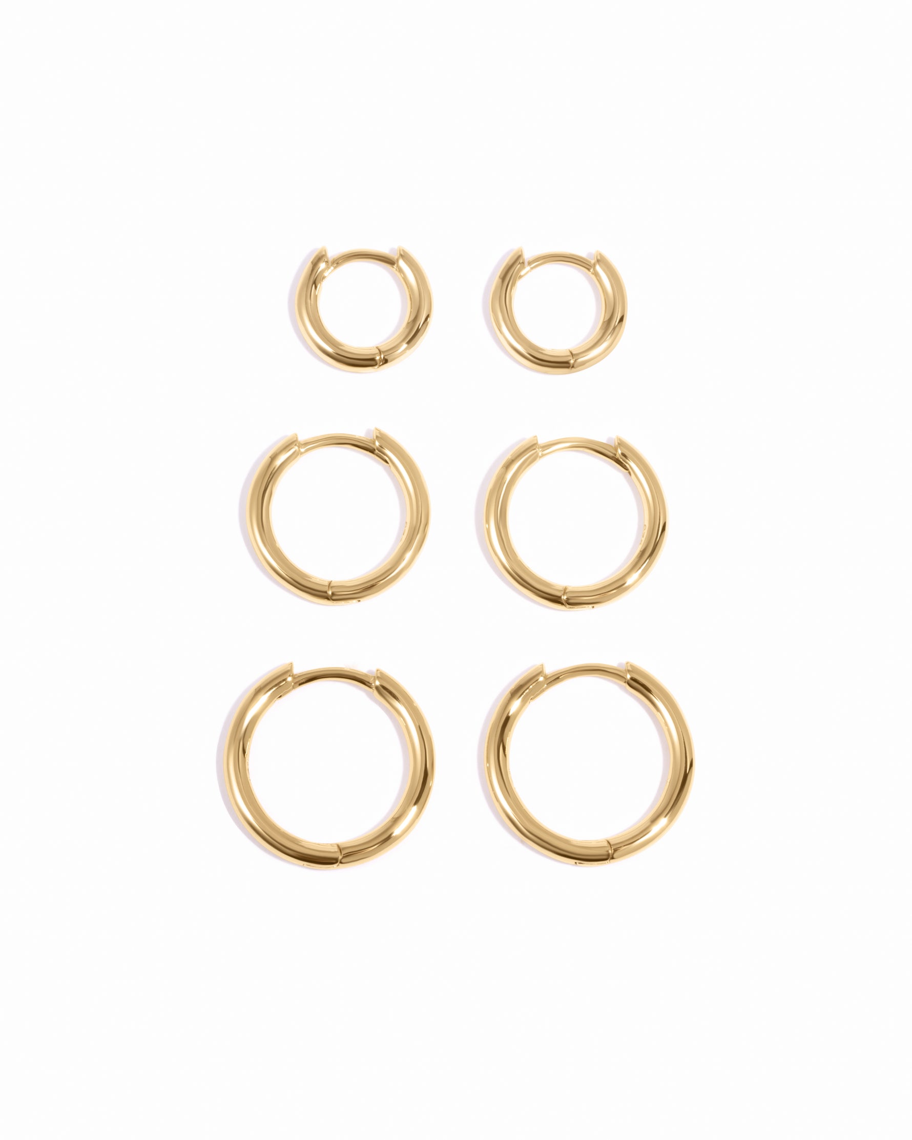 Gold small, medium, and big minimalist hoop earrings in a set