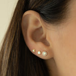 Model wearing dainty opal gold stud earrings stack. 