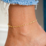 Model wearing gold small dainty ankle bracelet 