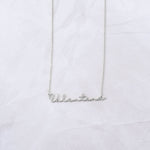 Sterling silver custom script necklace on marble background