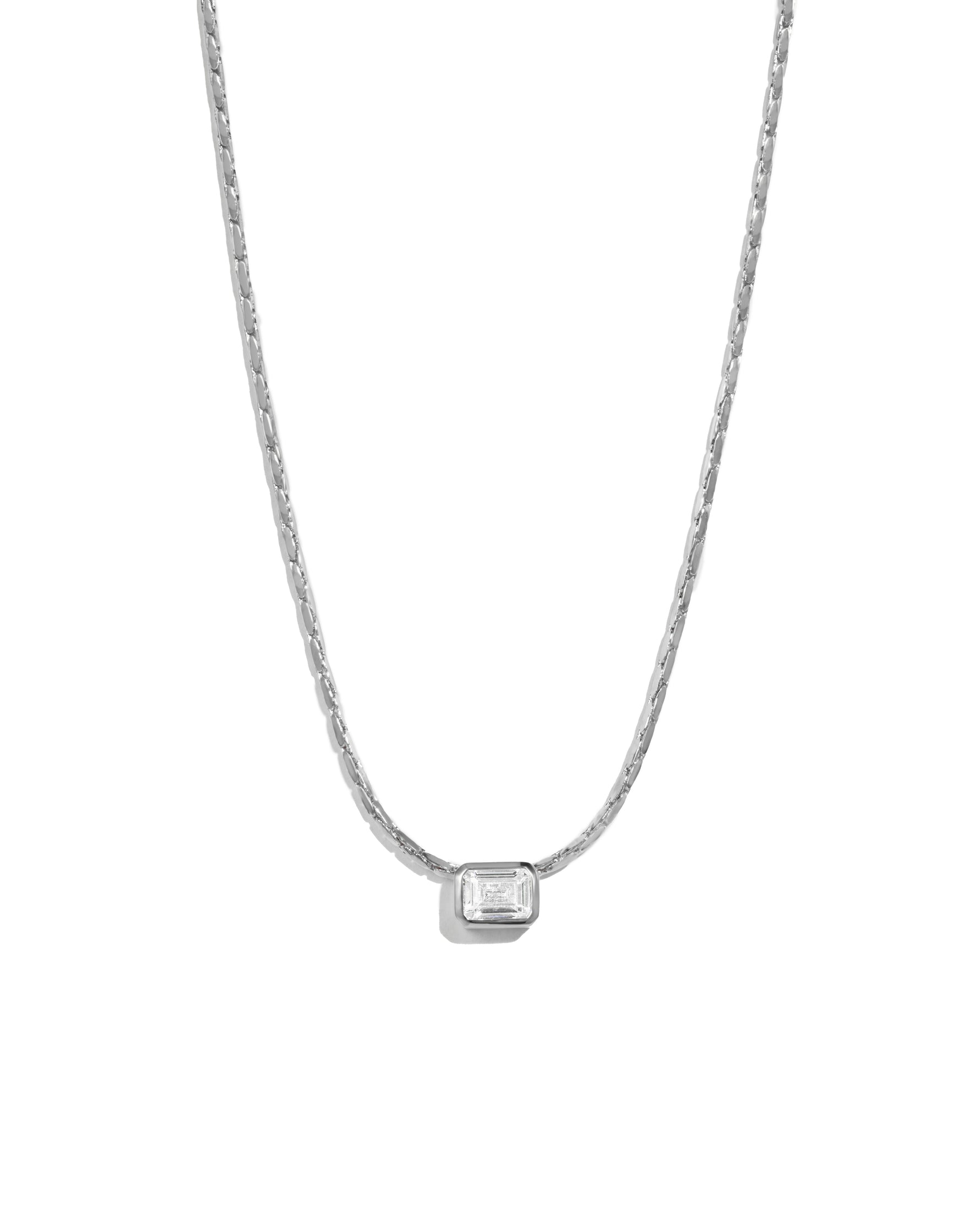 Silver baguette bezel diamond statement pendant necklace on white background